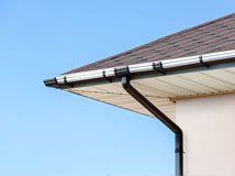 New gutter and downspout on a residential roofline