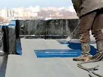 Torch-applied low-slope roofing being installed